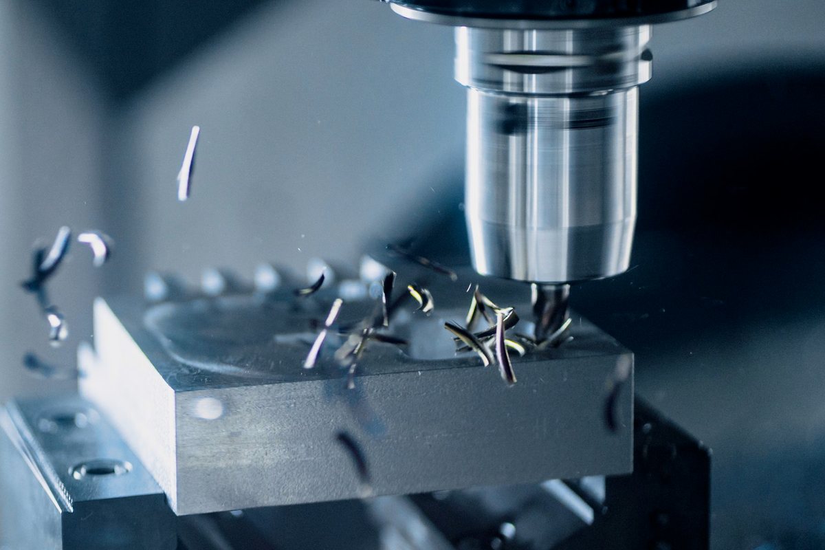 CNC milling machine cutting a precision metal part